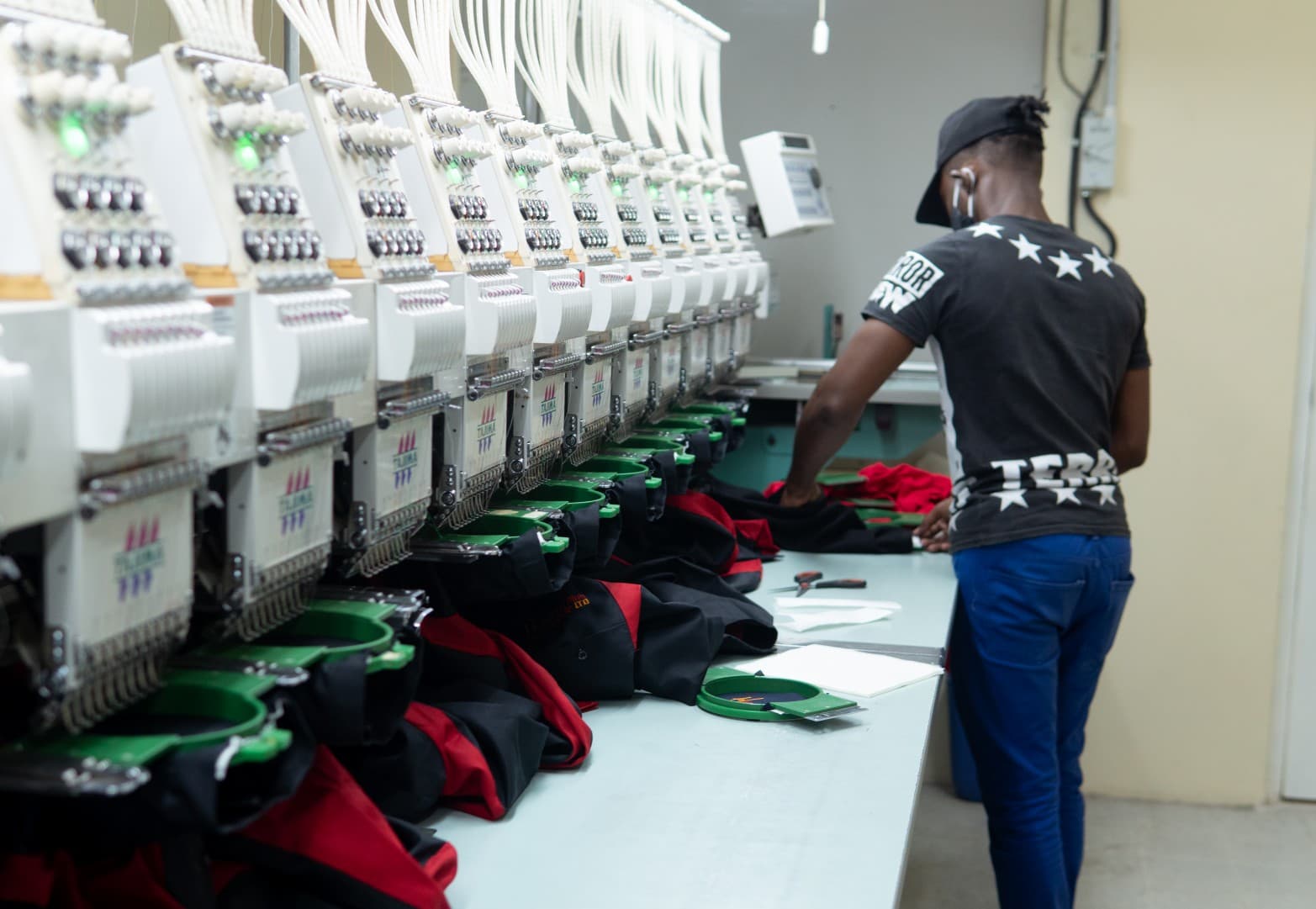Embroidery machines running a batch of uniforms at the Soccer Xpress production floor